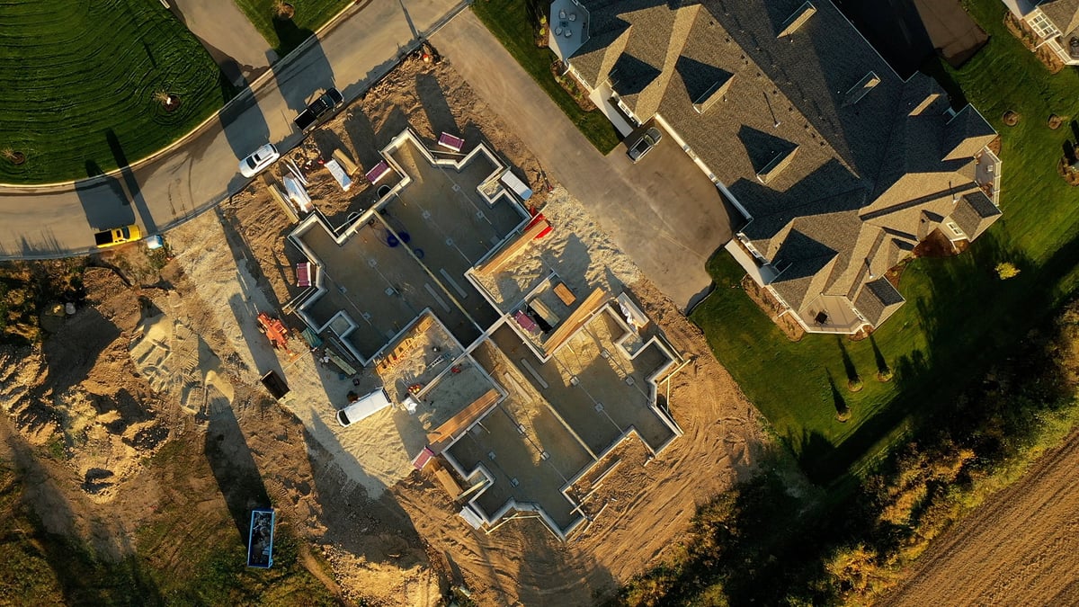 Aerial view of a single-family home under construction on its lot