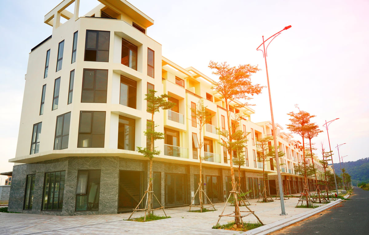 Modern Texas-style mixed-use development with retail storefronts on the ground floor and condominium residences above