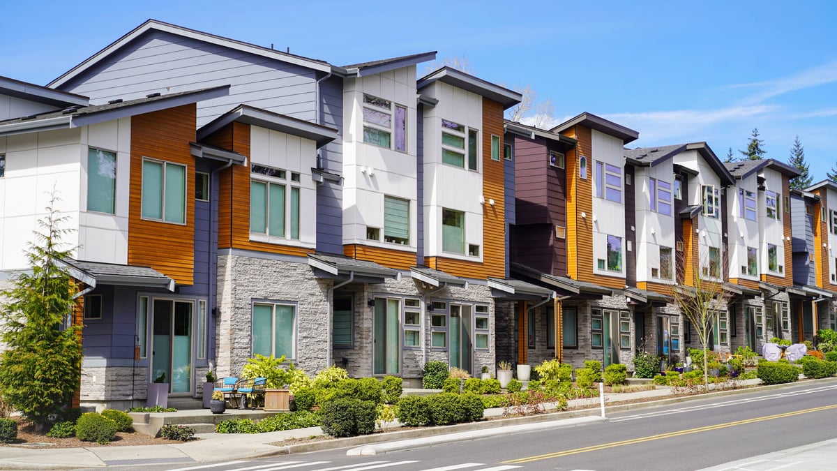 A row of modern townhomes in a residential neighborhood community